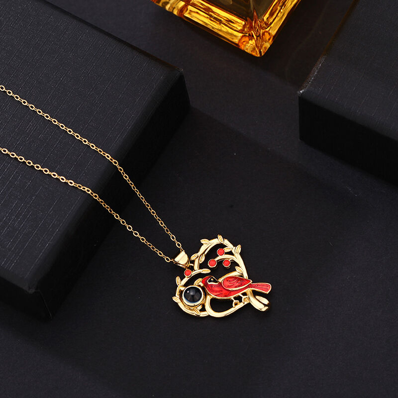 Halsband med projicerad bild av kardinalfågel i hjärta "Vi är alltid med dig